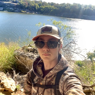 Luke outdoors by a lake